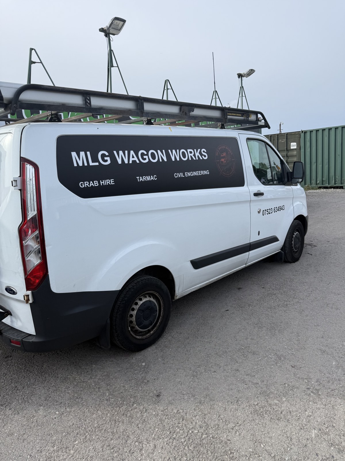 White MLG Wagon Works van with business name, services and contact lettering